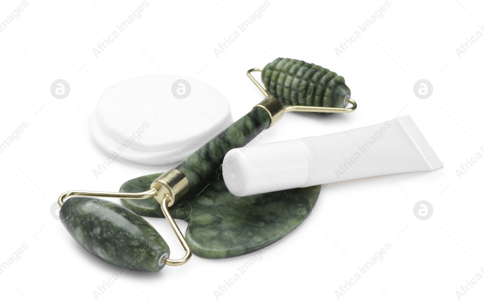 Photo of Face roller, cosmetic product and gua sha tool isolated on white