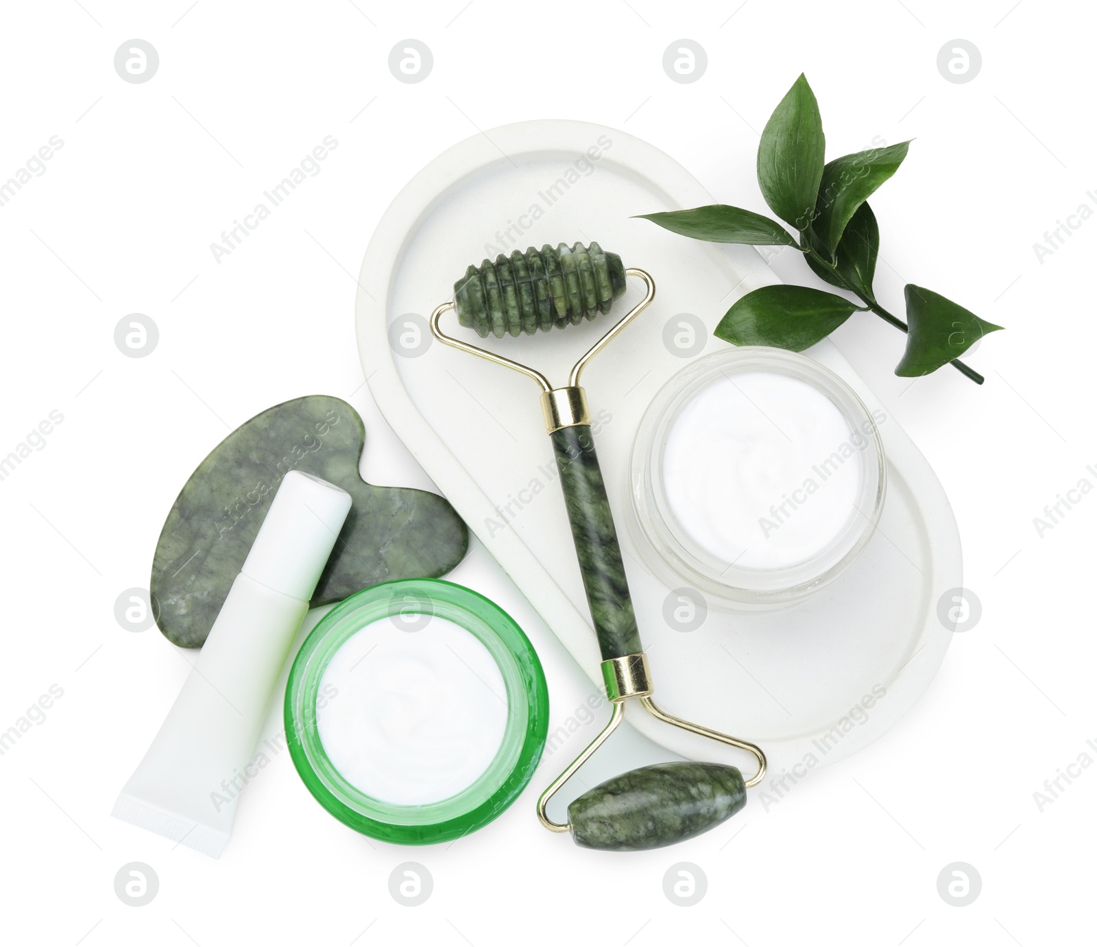 Photo of Face roller, cosmetic products and gua sha isolated on white