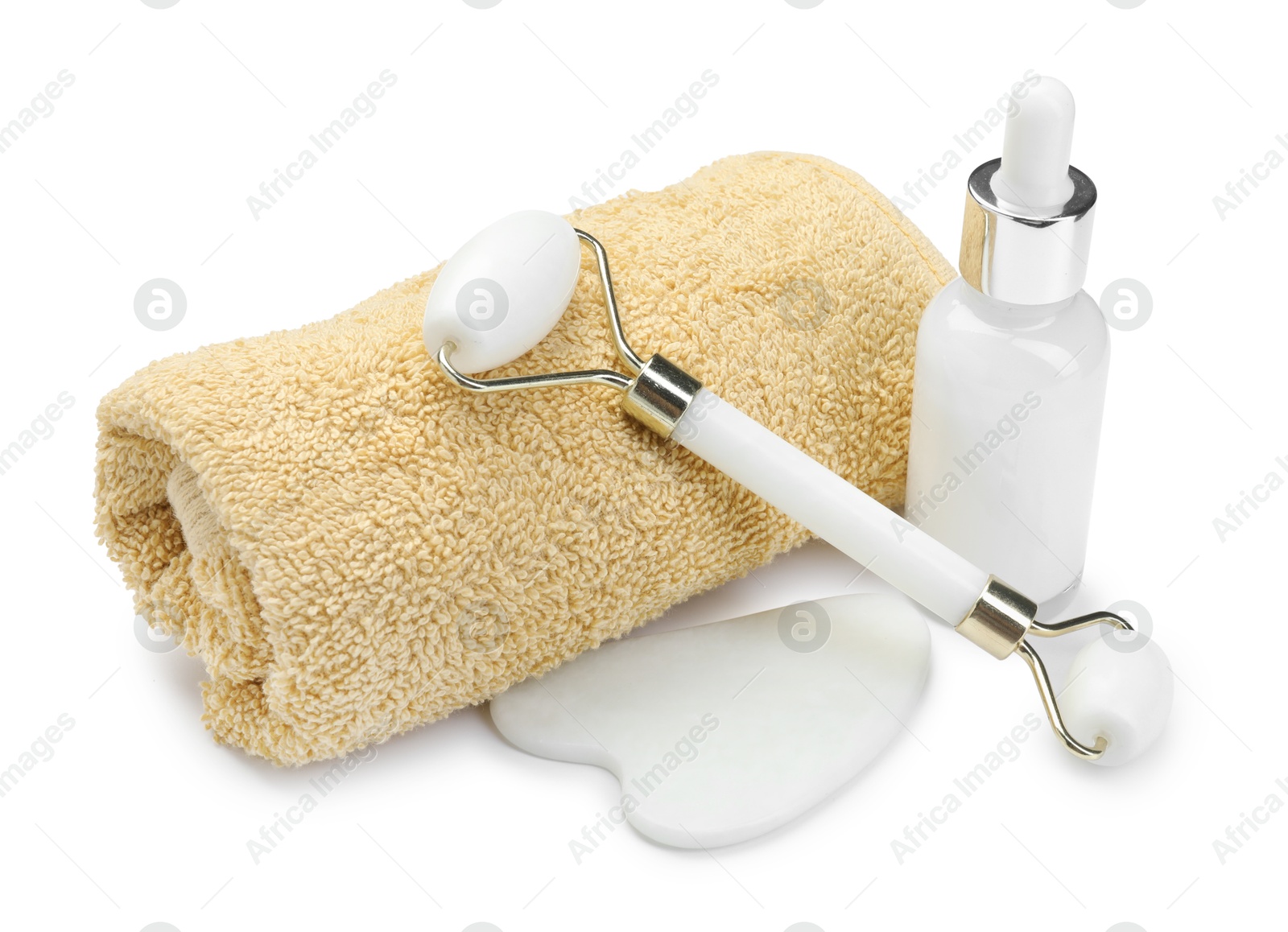 Photo of Face roller, gua sha tool, bottle and towel isolated on white