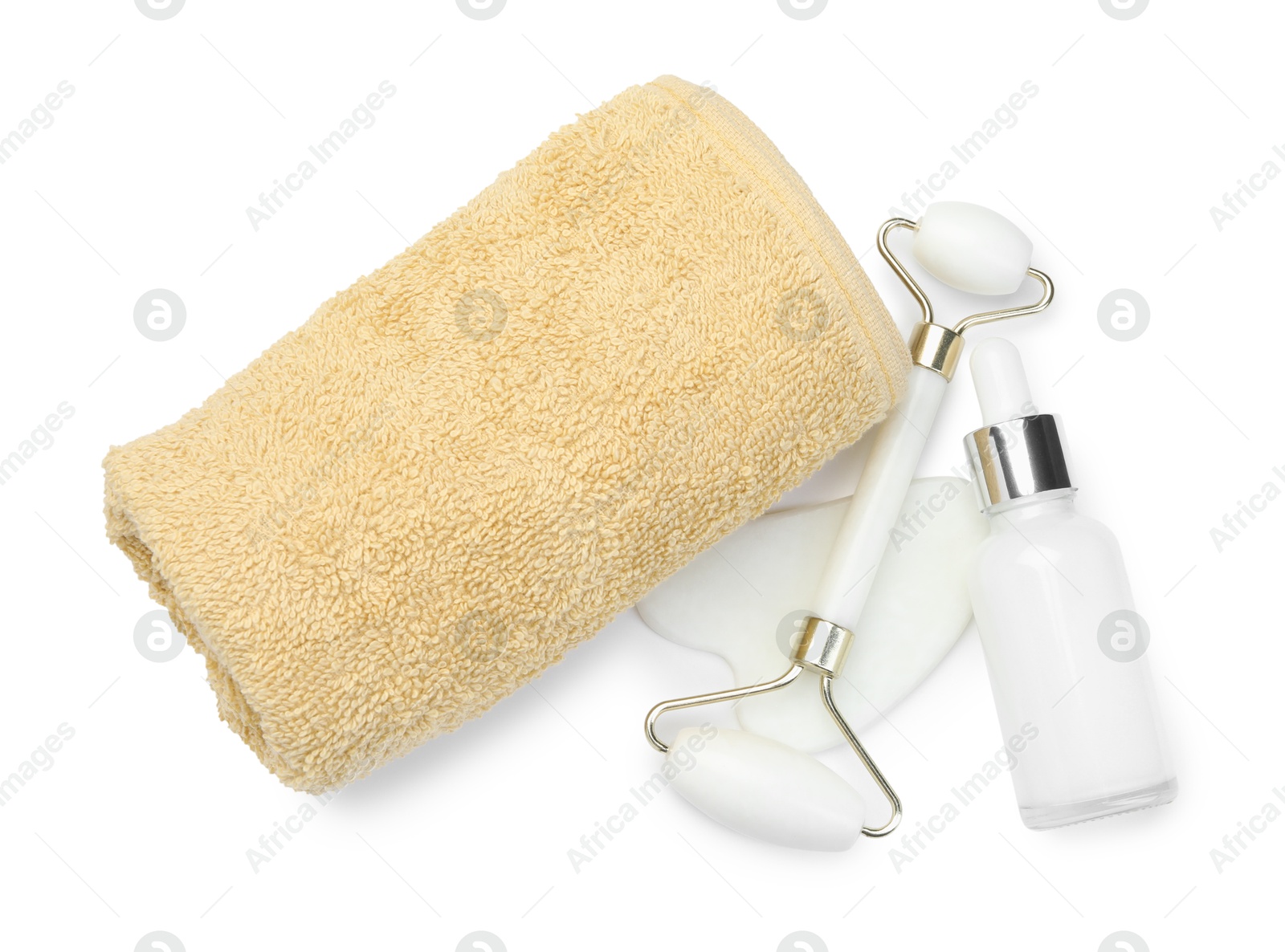 Photo of Face roller, gua sha tool, bottle and towel isolated on white, top view