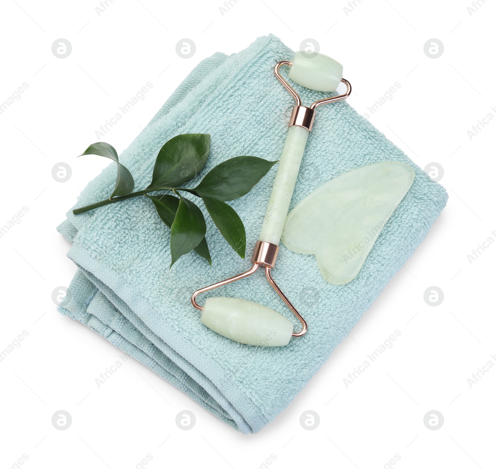 Photo of Face roller, gua sha tool and towel isolated on white, top view