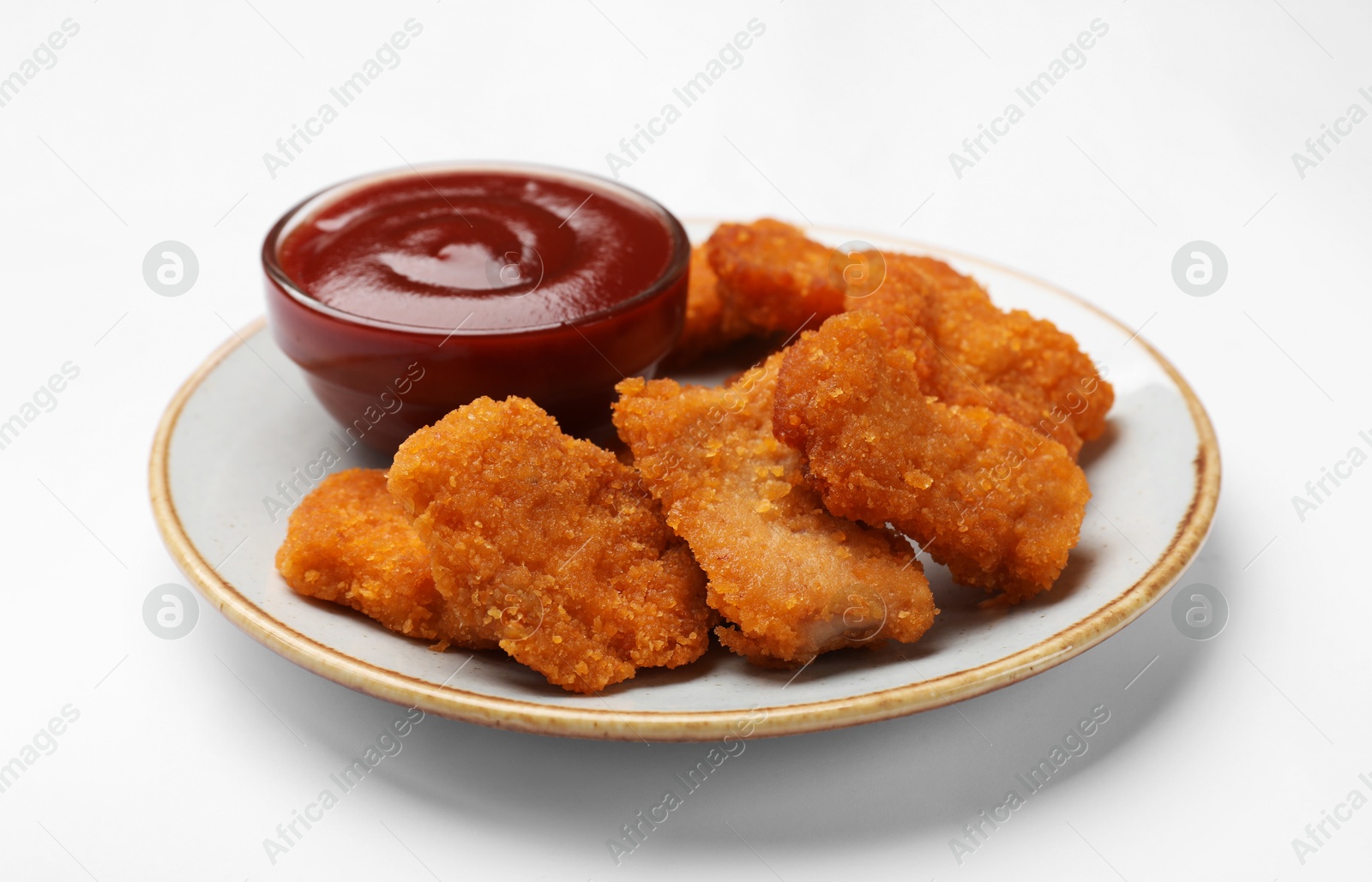 Photo of Delicious chicken nuggets with ketchup on white background