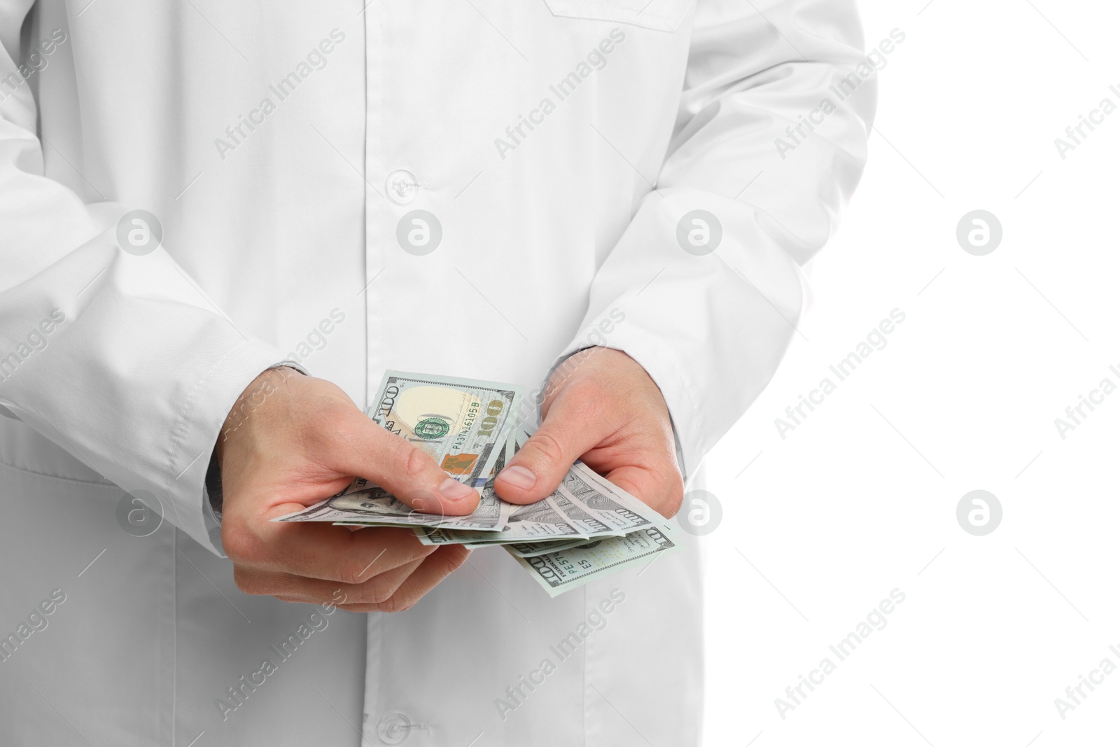 Photo of Corruption concept. Doctor with dollar banknotes on white background, closeup