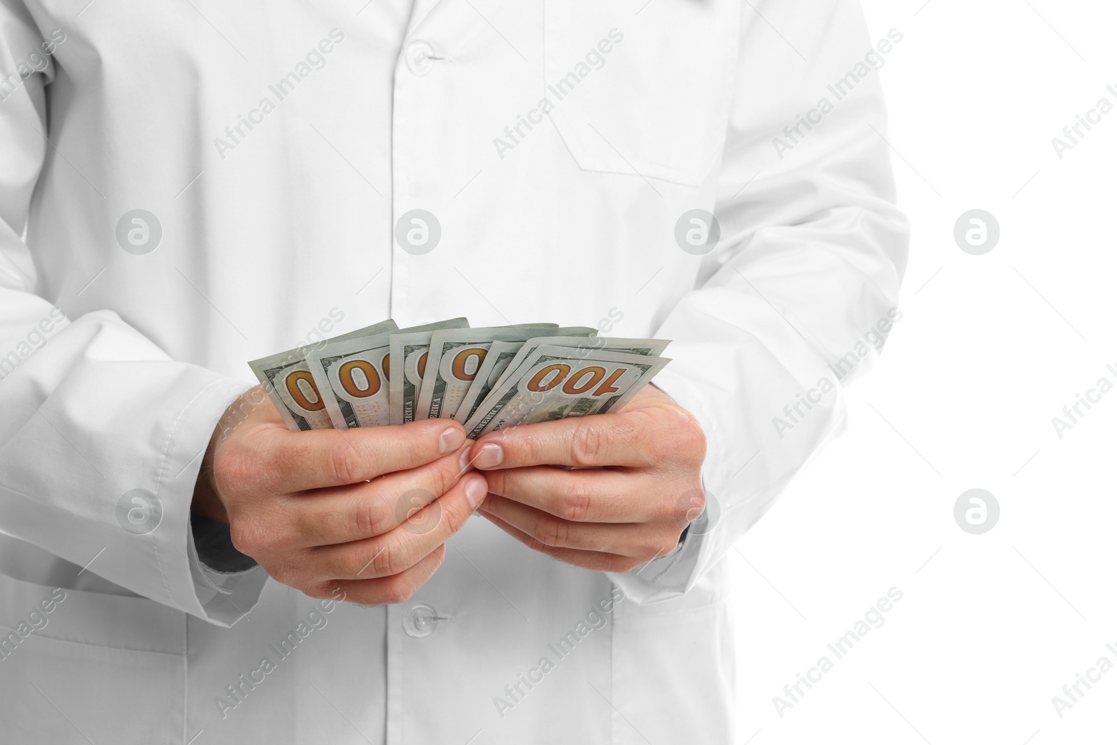 Photo of Corruption concept. Doctor with dollar banknotes on white background, closeup