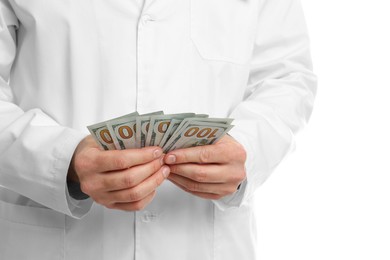 Photo of Corruption concept. Doctor with dollar banknotes on white background, closeup