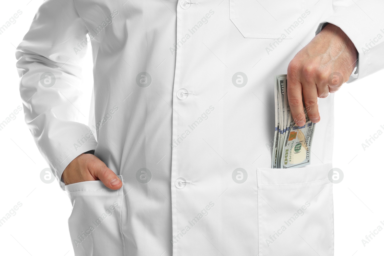 Photo of Corruption concept. Doctor putting dollar banknotes into his pocket on white background, closeup