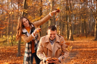 Photo of Happy couple spending time together in autumn park