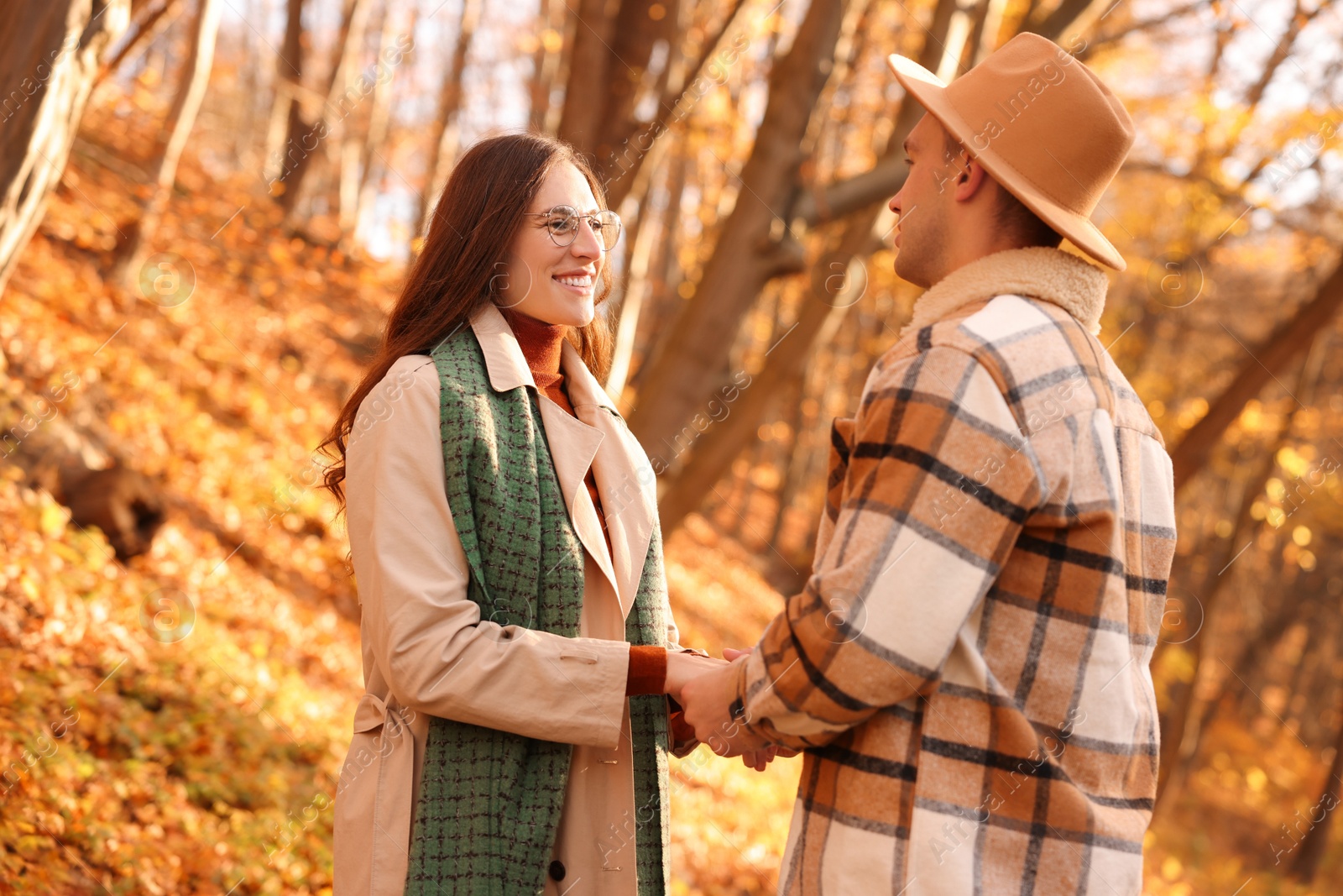 Photo of Happy couple spending time together in autumn park