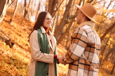 Photo of Happy couple spending time together in autumn park