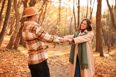 Photo of Happy couple spending time together in autumn park