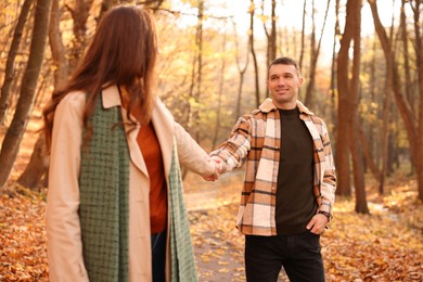 Photo of Happy couple spending time together in autumn park