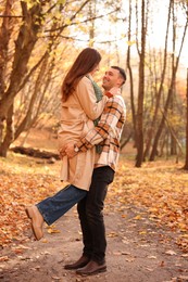 Photo of Happy couple spending time together in autumn park