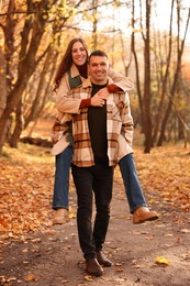 Photo of Happy couple spending time together in autumn park