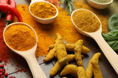 Different aromatic spices on wooden table, closeup