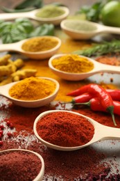 Photo of Different aromatic spices and herbs on table, closeup