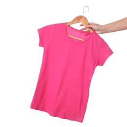 Photo of Woman holding hanger with beautiful t-shirt on white background, closeup