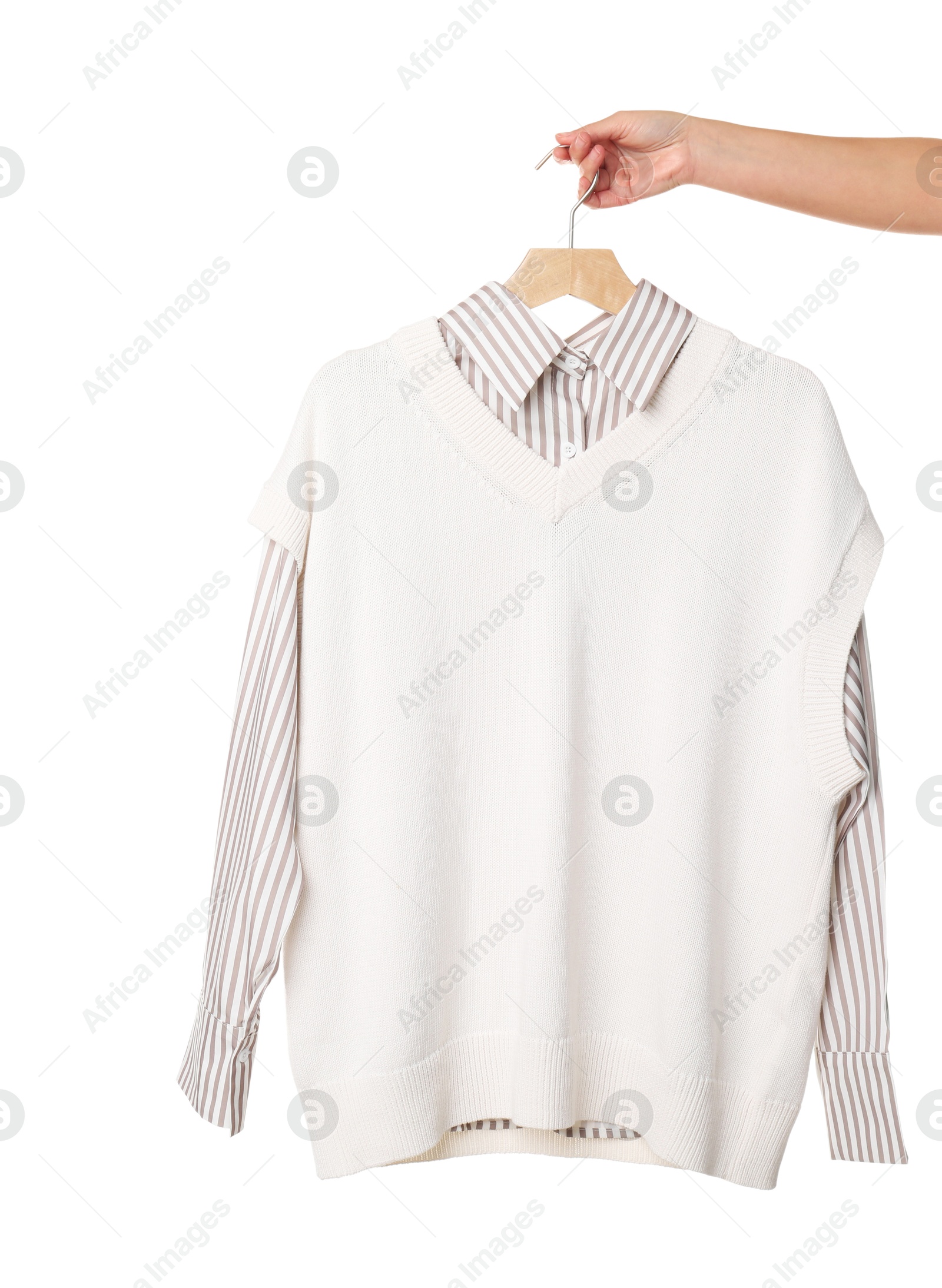 Photo of Woman holding hanger with beautiful clothes on white background, closeup