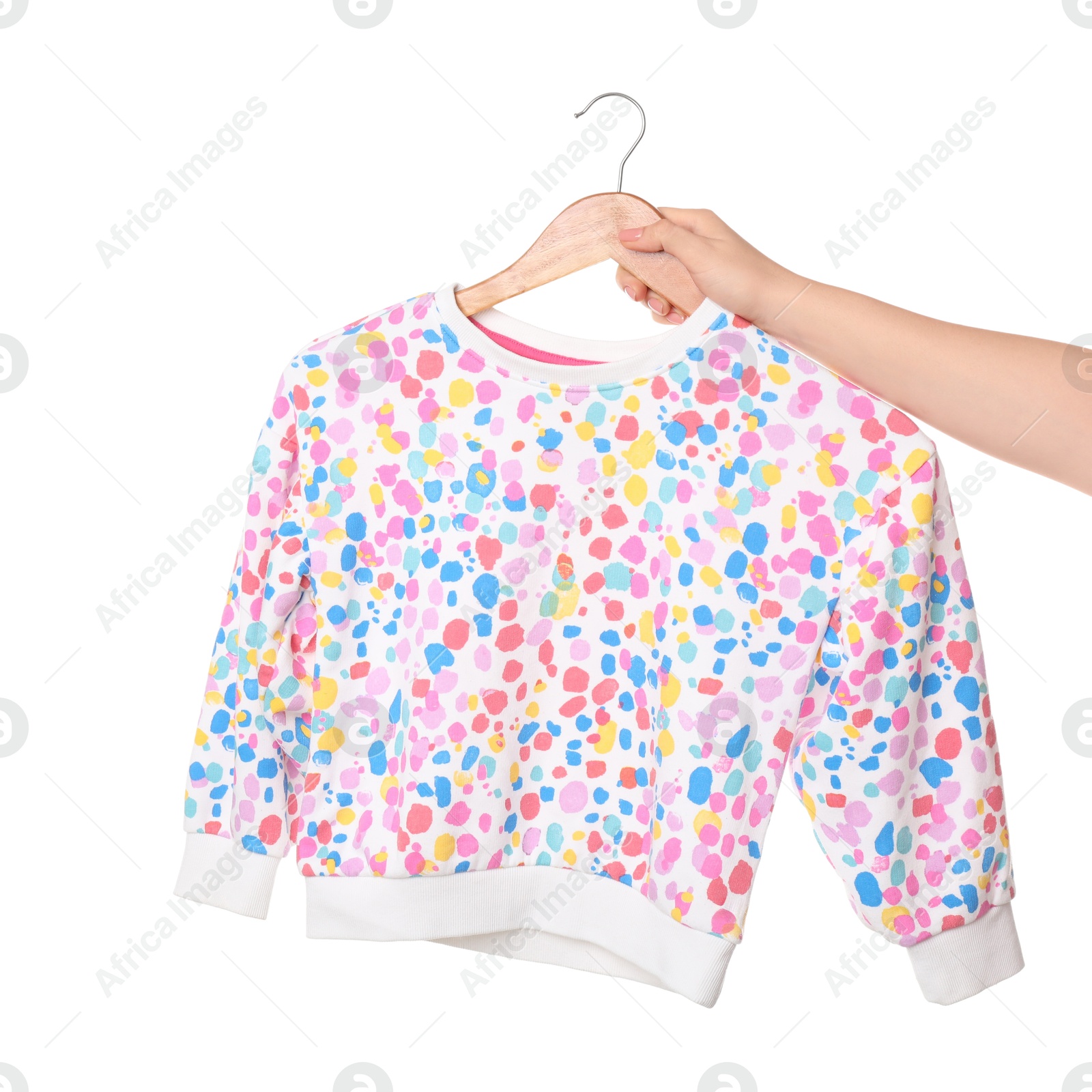 Photo of Woman holding hanger with beautiful baby sweater on white background, closeup