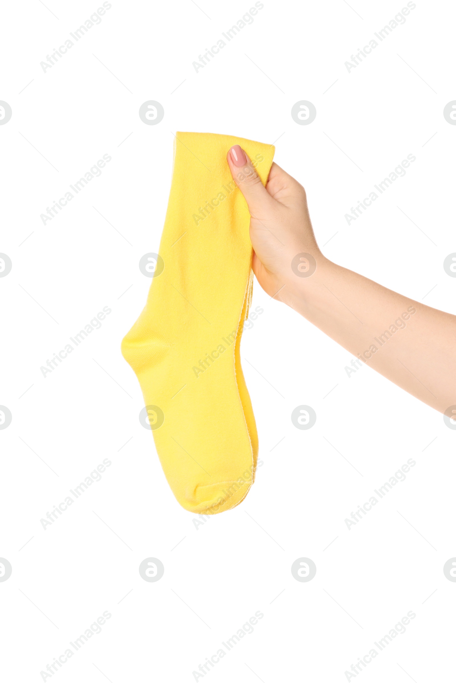 Photo of Woman holding pair of yellow socks on white background, closeup