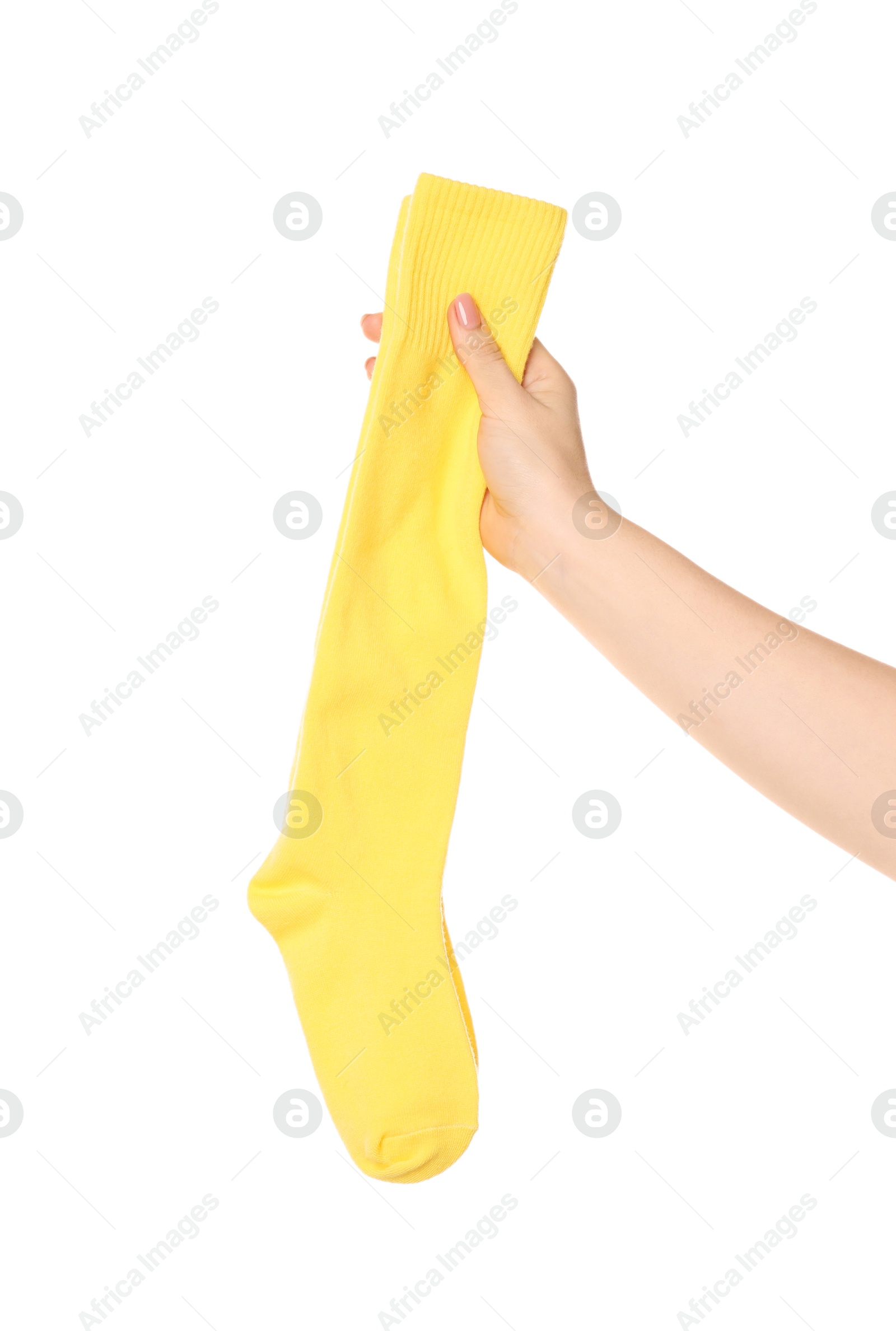 Photo of Woman holding pair of yellow socks on white background, closeup