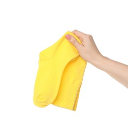 Photo of Woman holding pair of yellow socks on white background, closeup