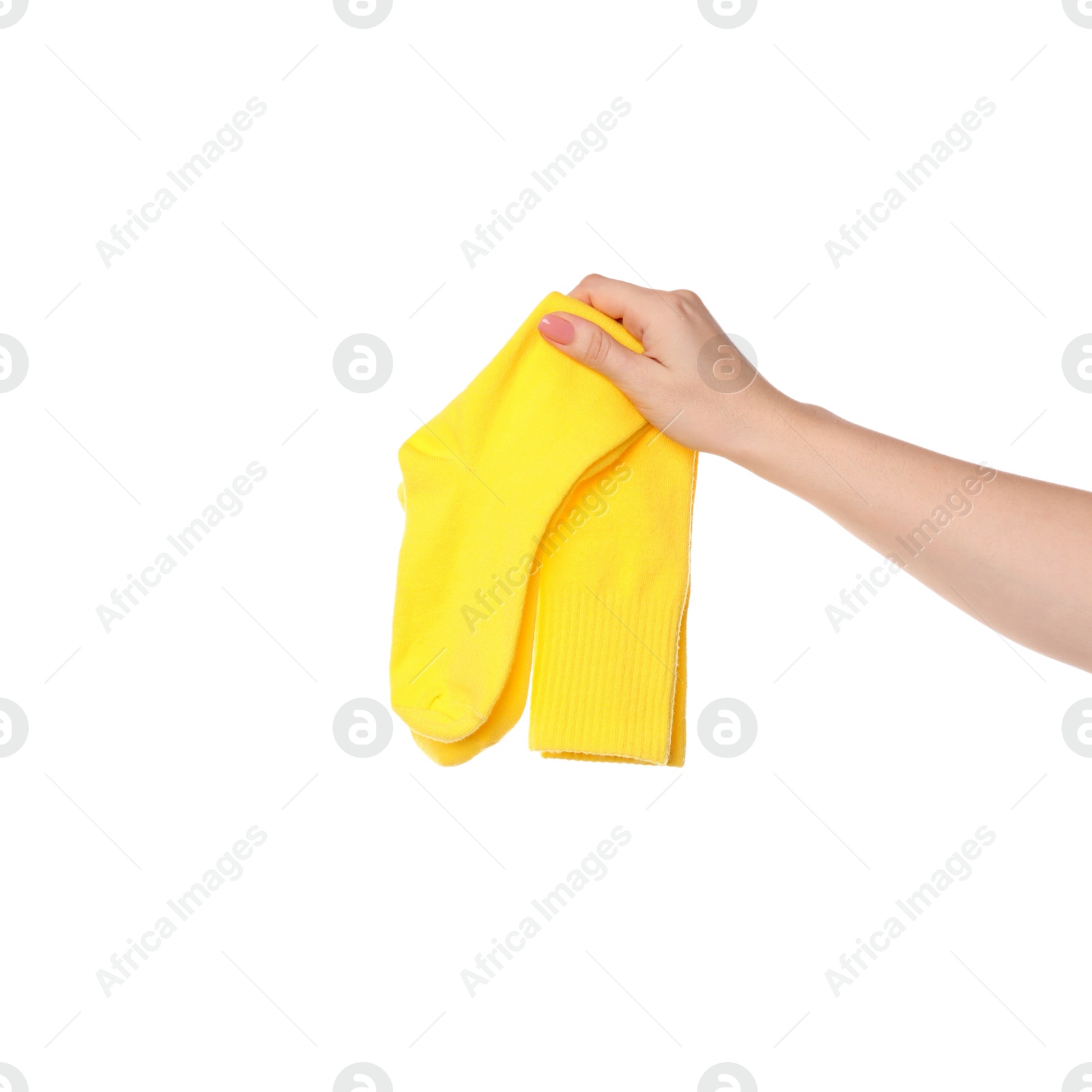 Photo of Woman holding pair of yellow socks on white background, closeup