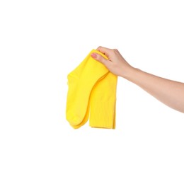 Photo of Woman holding pair of yellow socks on white background, closeup