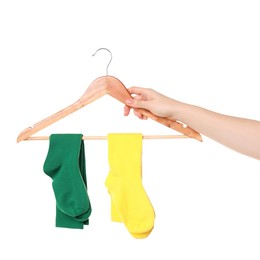 Photo of Woman holding hanger with bright socks on white background, closeup