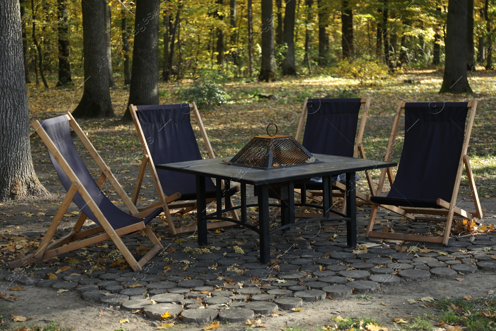 Photo of Picnic table and chairs in beautiful autumnal forest