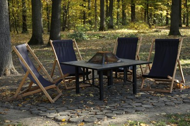 Picnic table and chairs in beautiful autumnal forest