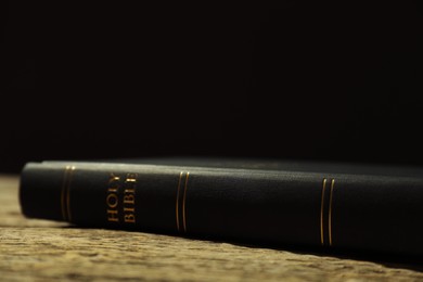 Hardcover Holy Bible on wooden table, closeup. Space for text