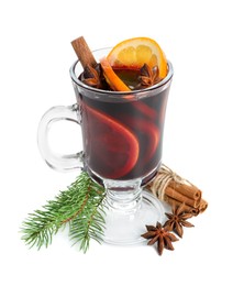 Tasty mulled wine, spices, orange slices and fir branches isolated on white. Christmas drink