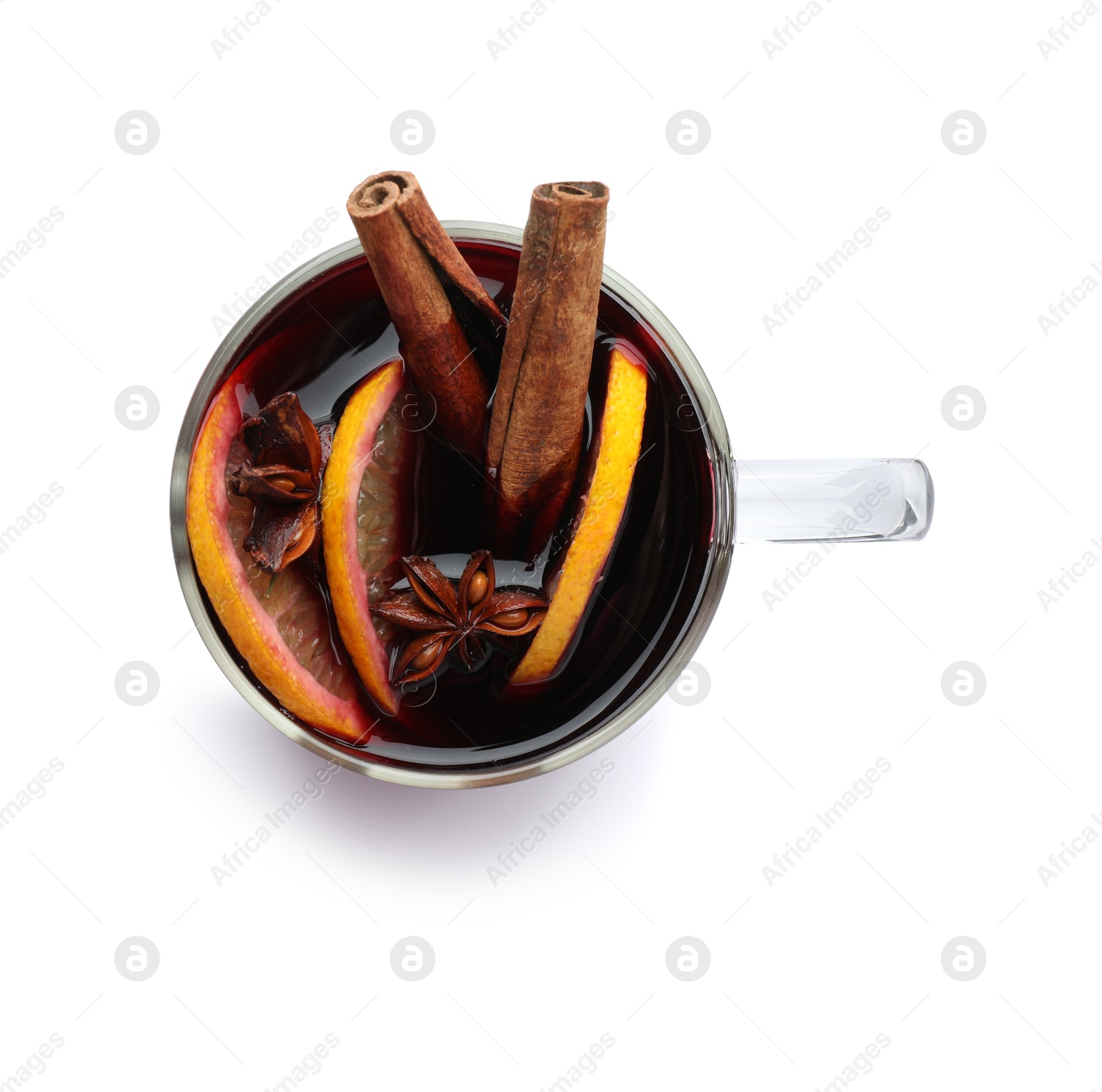 Photo of Tasty mulled wine with spices and orange slices in cup isolated on white, top view. Christmas drink