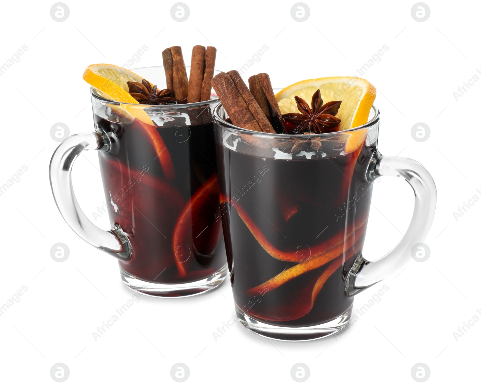 Photo of Tasty mulled wine with spices and orange slices in cups isolated on white. Christmas drink