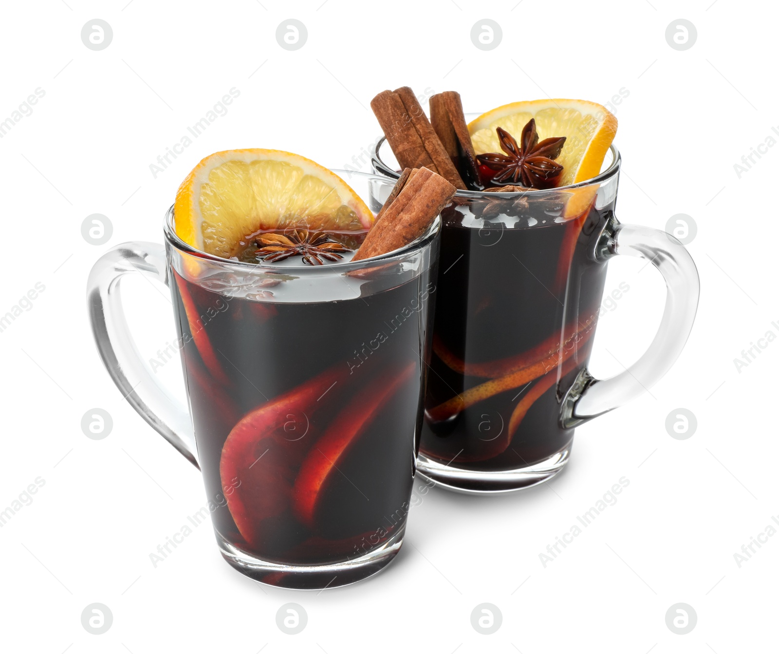 Photo of Tasty mulled wine with spices and orange slices in cups isolated on white. Christmas drink