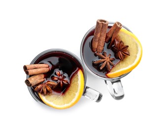 Photo of Tasty mulled wine with spices and orange slice in cups on white background, top view. Christmas drink