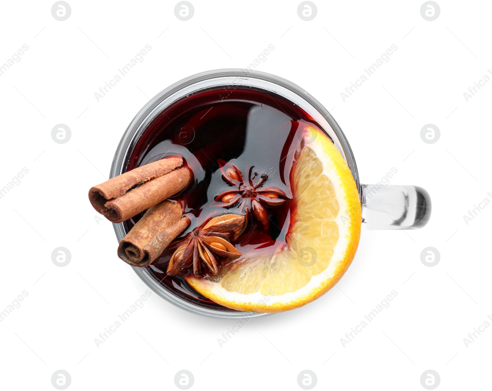 Photo of Tasty mulled wine with spices and orange slices in cup isolated on white, top view. Christmas drink