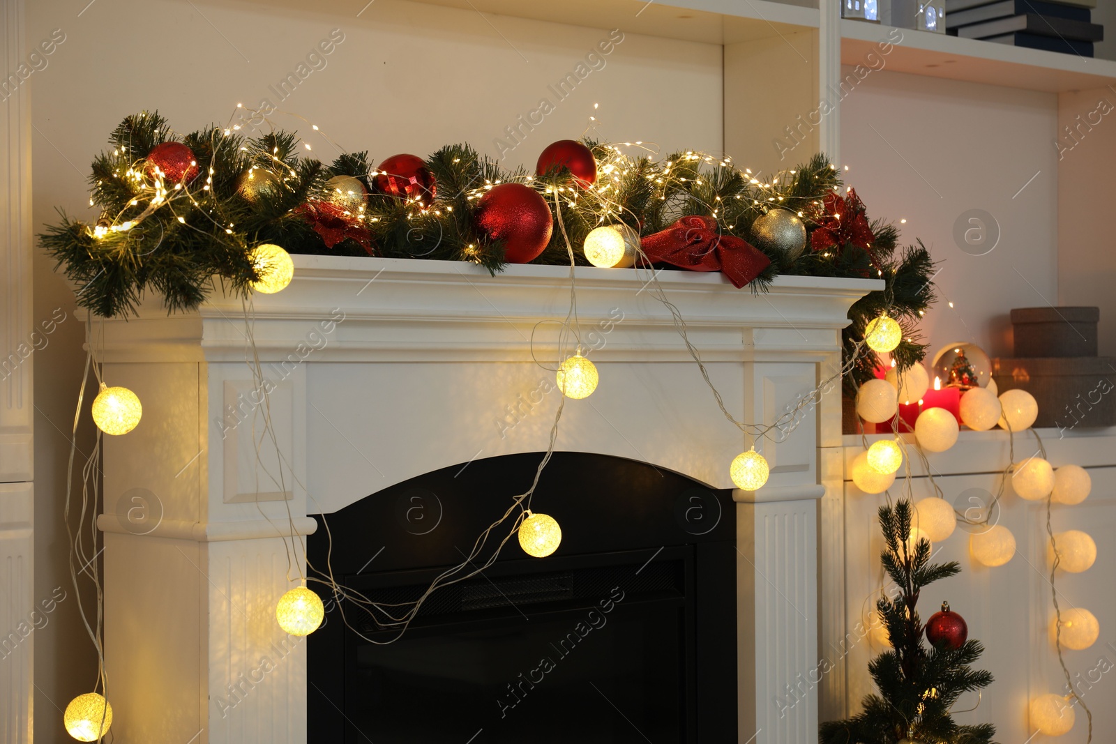 Photo of Stylish fireplace with Christmas decor in cozy room