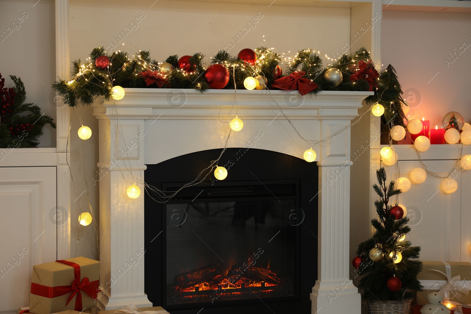 Photo of Stylish fireplace with Christmas decor and presents in cozy room