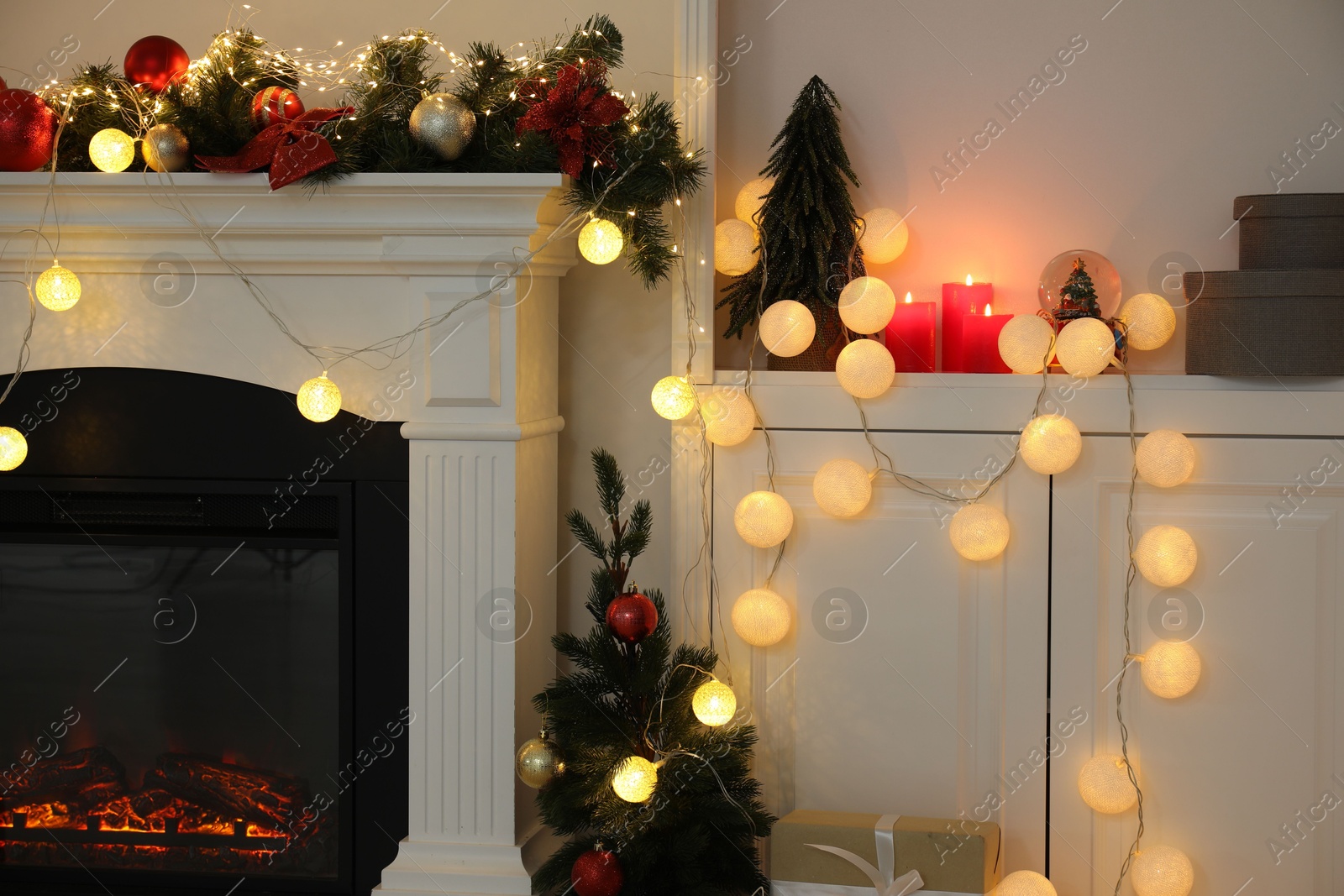 Photo of Stylish fireplace with Christmas decor in cozy room