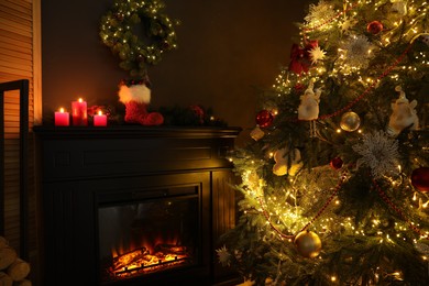 Photo of Fireplace with festive decor and Christmas tree indoors