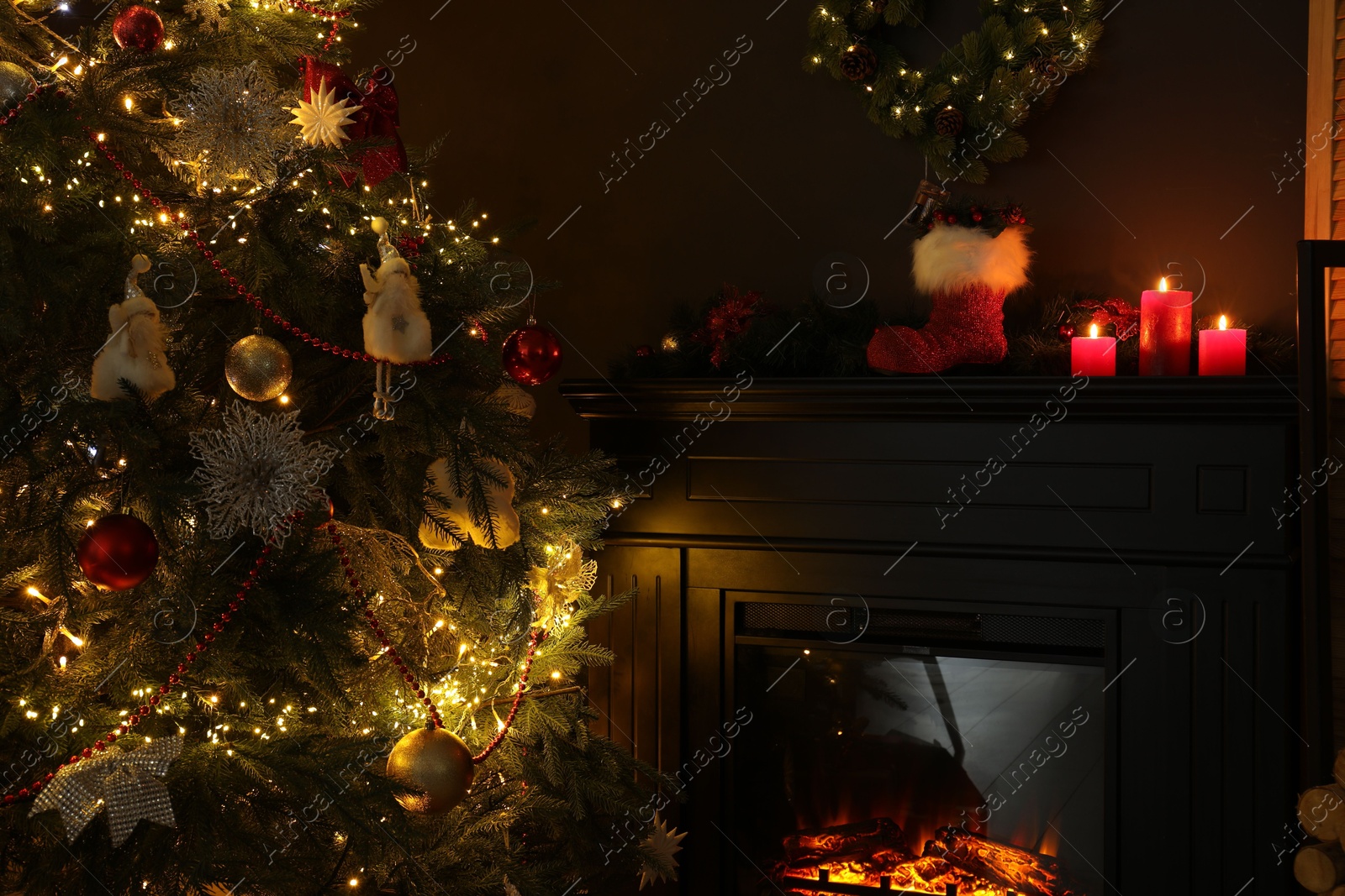 Photo of Fireplace with festive decor and Christmas tree indoors