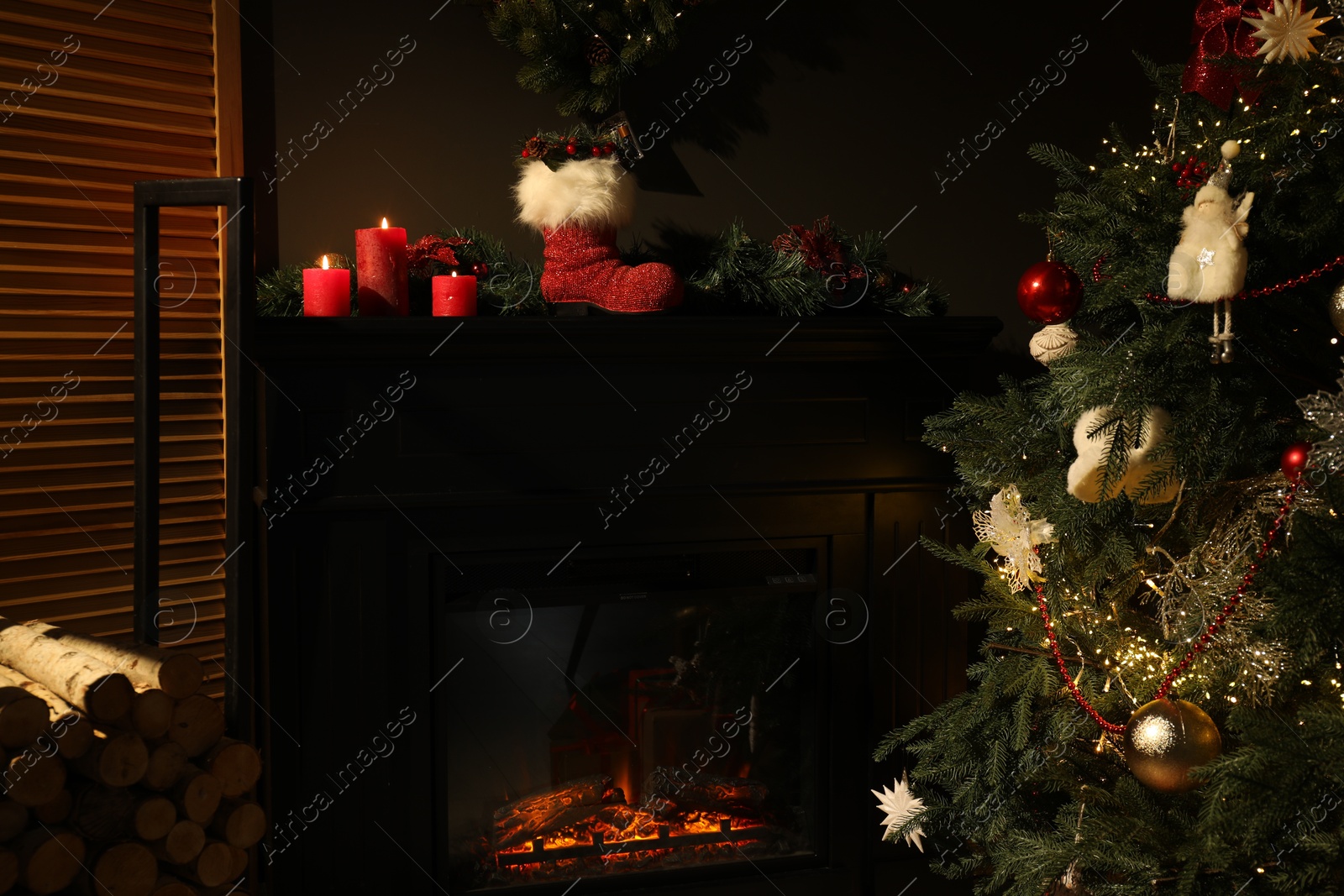 Photo of Fireplace with festive decor and Christmas tree indoors