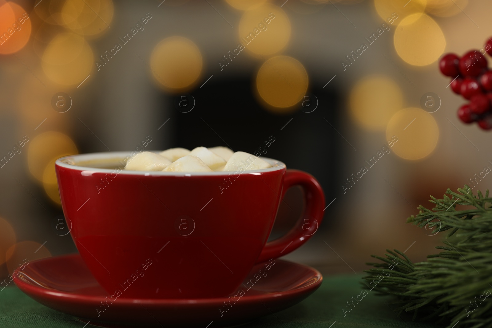 Photo of Tasty cocoa with marshmallows in cup and decor on table against blurred Christmas lights, closeup. Bokeh effect