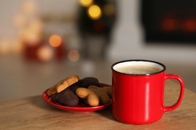 Photo of Tasty cocoa in cup and cookies on wooden table. Christmas drink