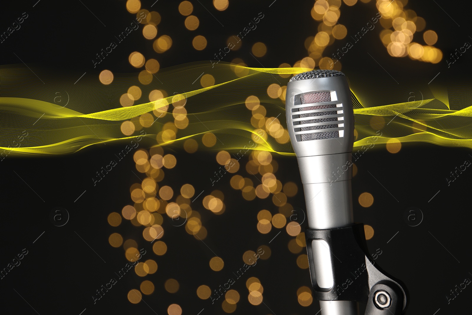 Image of Sound wave and microphone against black background with blurred lights