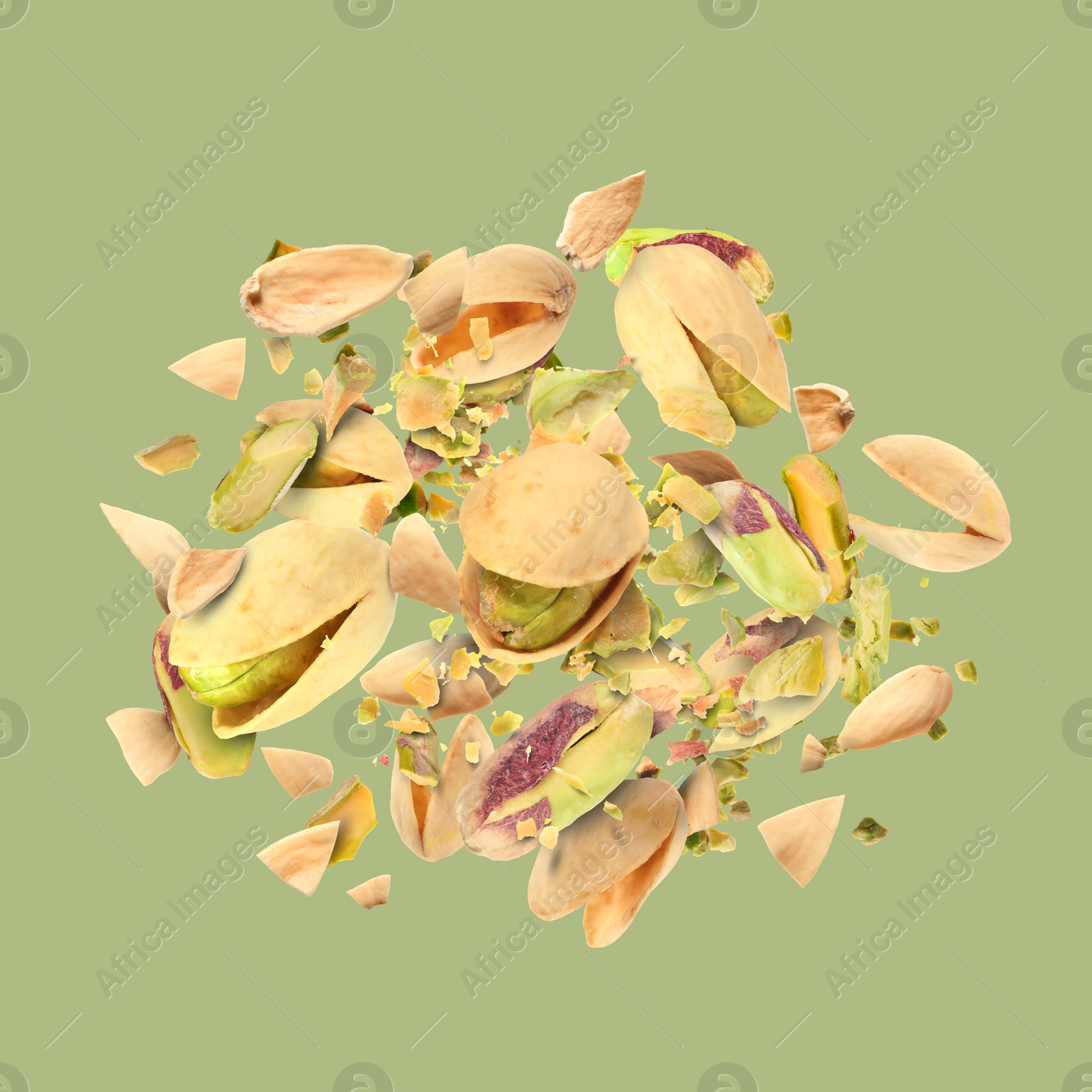 Image of Tasty pistachios with cracked nutshell in air on color background