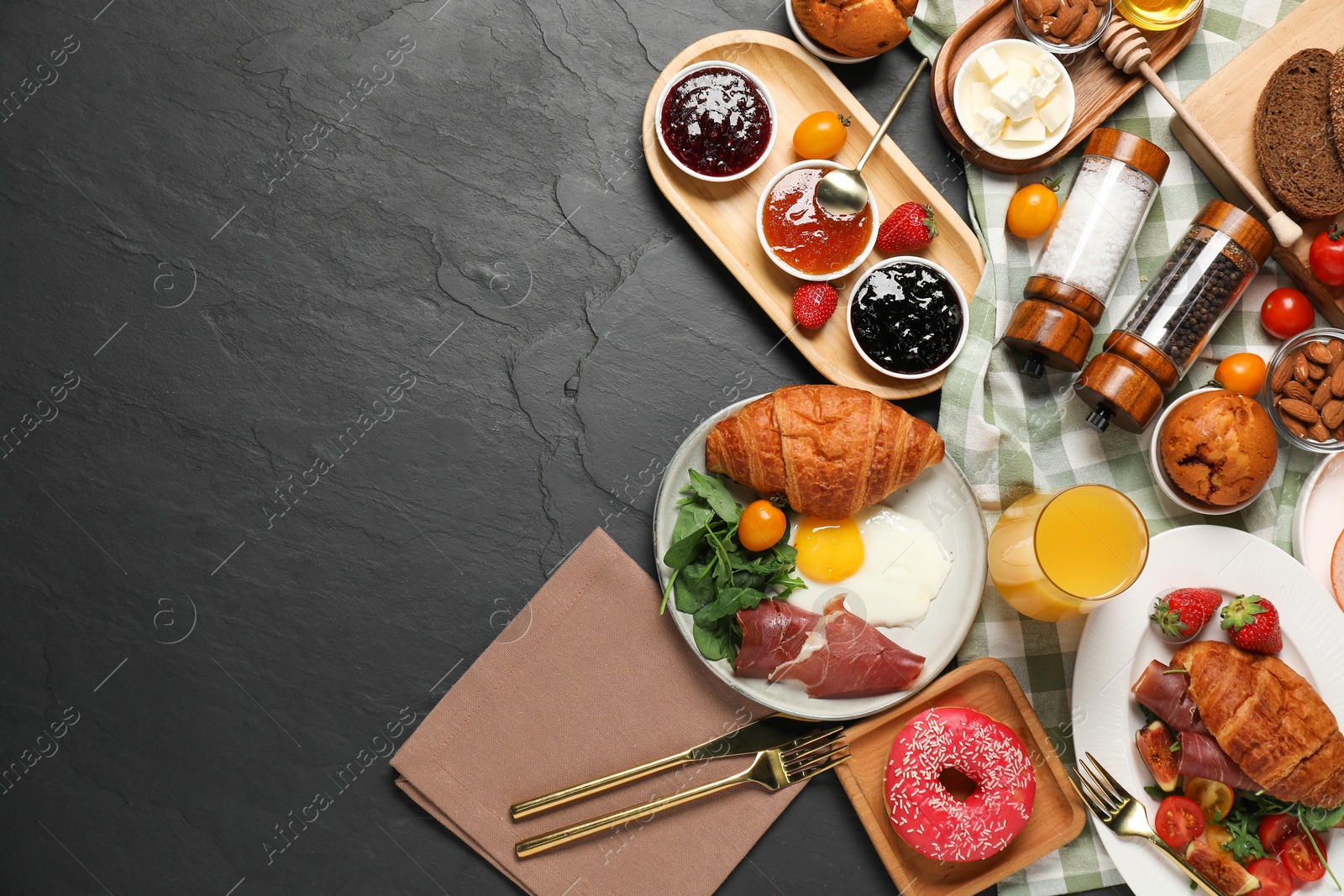 Photo of Different tasty food served for brunch on grey textured table, flat lay. Space for text