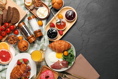 Photo of Different tasty food served for brunch on grey textured table, flat lay. Space for text