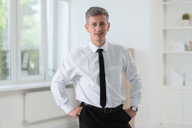 Photo of Portrait of handsome businessman posing in office